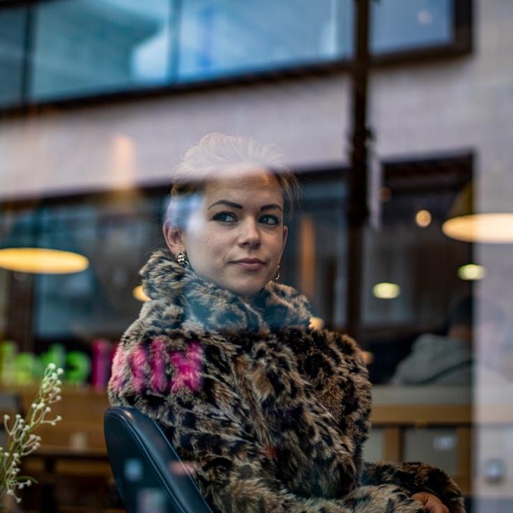 Alex Rivera, Lead Design Curator at OakHarborStudio, reviewing corporate floral arrangements